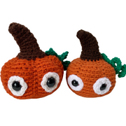 pumpkin plush toy - two crocheted amigurumi pumpkins against a white background