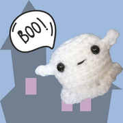 ghost plush toy - crochet amigurumi ghost saying Boo! against a blue and haunted house background