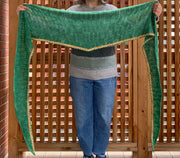 easy crochet shawl pattern triangle - image shows middle aged woman holding shawl open to show its full width